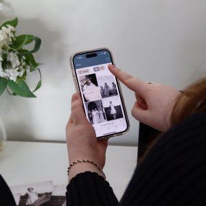 Person viewing memorial photos on smartphone for remembrance.