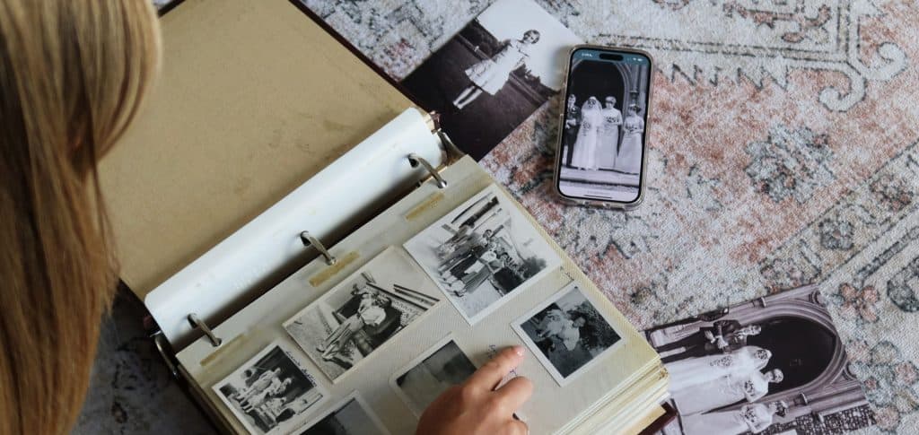 Memorial photo sharing and remembrance - honorpix Person viewing a photo album with black and white memorial photos and a smartphone.