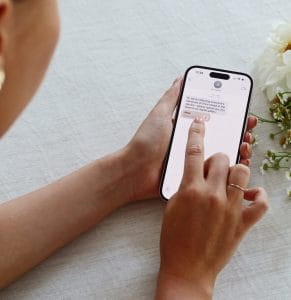 Person viewing a memorial message on a smartphone screen.