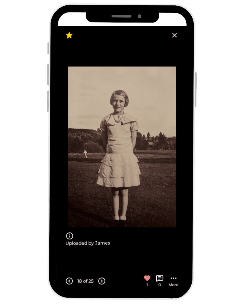 Vintage photo of a young girl in a dress standing outdoors.