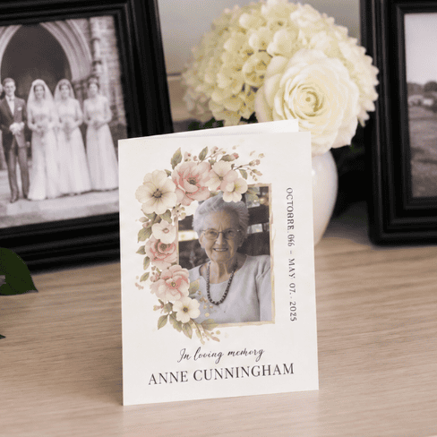 Memorial card for Anne Cunningham with floral design and photo.