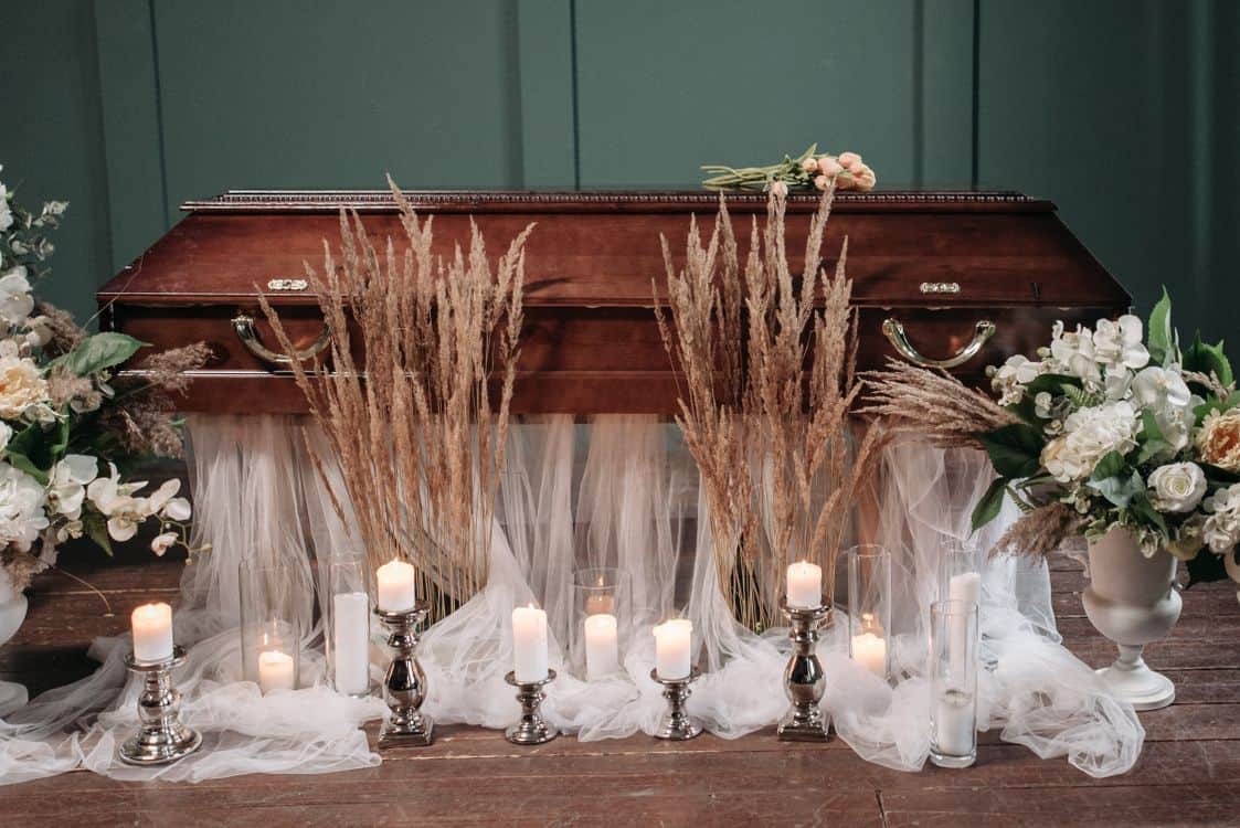 Warm burning candles and delicate flowers in an elegant and peaceful memorial setting