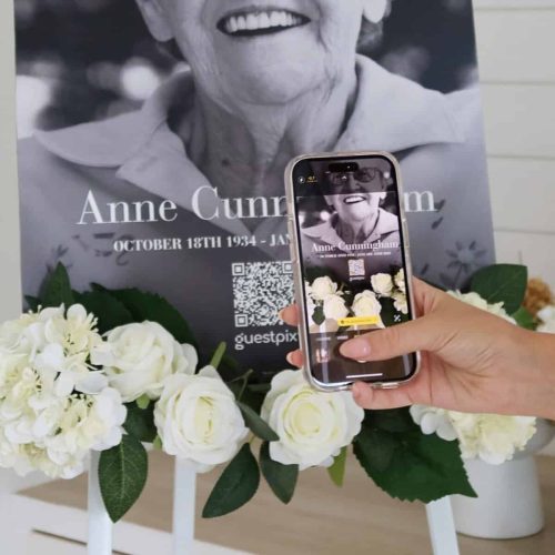 Person scanning memorial QR code for remembrance keepsake.